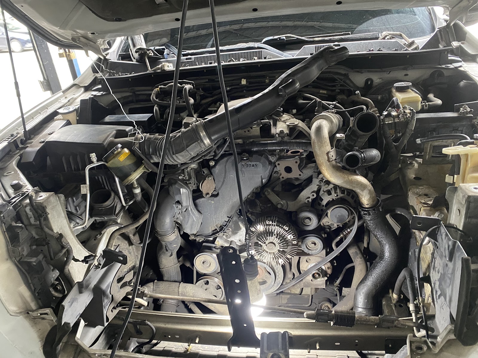 Motor de un Nissan durante una intervención completa del sistema de aire acondicionado